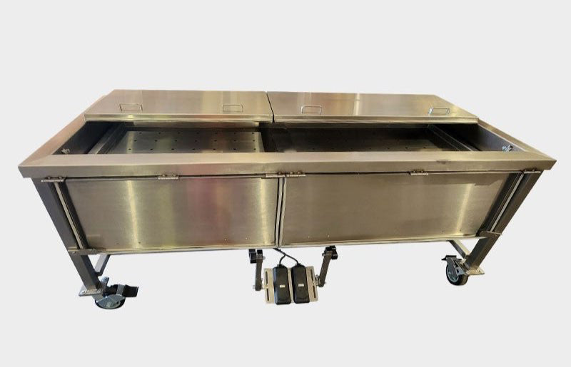 Close-up of the perforated stainless steel inner tray and cable-guided electric lift system for cadaver submersion.