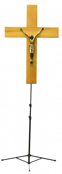 Double-sided crucifix on adjustable stand extending above an open casket lid